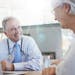 Shot of a doctor talking to a senior patient in his office. iStock