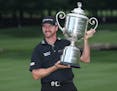 Jimmy Walker poses with the trophy after winning the PGA Championship golf tournament at Baltusrol Golf Club in Springfield, N.J., Sunday, July 31, 20