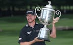 Jimmy Walker poses with the trophy after winning the PGA Championship golf tournament at Baltusrol Golf Club in Springfield, N.J., Sunday, July 31, 20