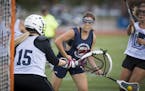 Kailey Heinl, center, scored during a recent summer league game. Heinl is one of 17 freshman recruits for the inaugural women’s lacrosse team at Con