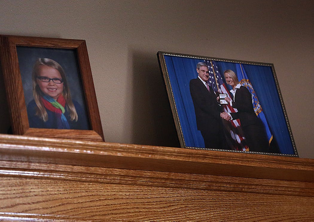 A photograph of Sylvia Hilgeman meeting with then-FBI Director Robert Mueller was displayed with other family photographs on the living room mantle. Hilgeman said of her upbringing, 