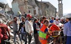 A victim is pulled out of the rubble following an earthquake in Amatrice Italy, Wednesday, Aug. 24, 2016. The magnitude 6 quake struck at 3:36 a.m. (0