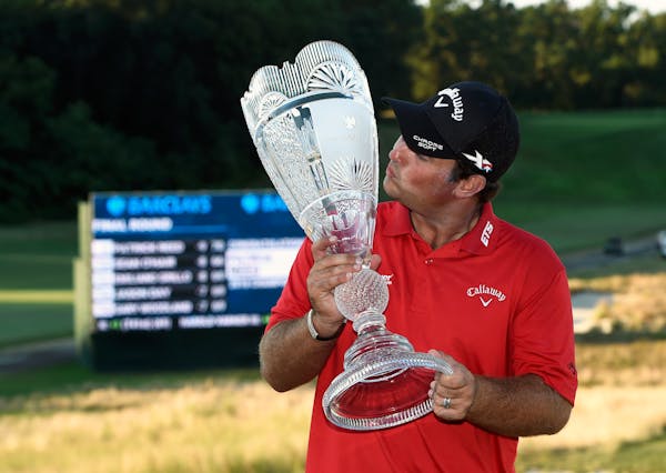 Patrick Reed kissed the trophy after winning The Barclays tournament on Sunday in Farmingdale, N.Y.