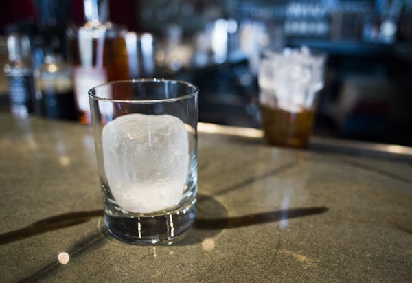 A cylinder ice form awaits a cocktail at Eat Street Social.