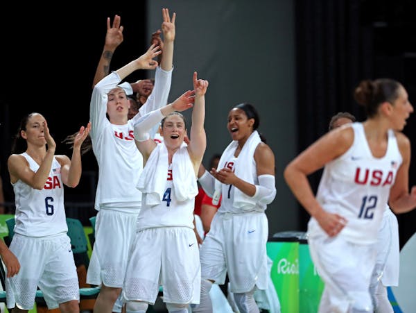 The Lynx’s Lindsay Whalen (4) and Maya Moore, right, took part in the cheers on the Team USA bench after Diana Taurasi sank a three-pointer in the g