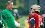 Notre Dame head coach Brian Kelly, left, and quarterback DeShone Kizer talk during NCAA college football practice Thursday, Aug. 11, 2016, in South Be