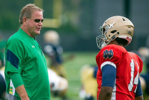 Notre Dame head coach Brian Kelly, left, and quarterback DeShone Kizer talk during NCAA college football practice Thursday, Aug. 11, 2016, in South Be