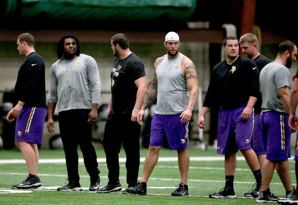 Alex Boone, with hat, joined other Vikings for drills during a player offseason workout at Winter Park in April.