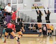 Taylor Wolf (14) and Ellie Dammann (15) blocked a shot by Bethlehem Academy's Payton Nutter (10). Waconia upset the top-ranked Cardinals in three game