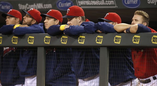 Minnesota Twins players lean on the dugout rail during the ninth inning of a baseball game against the Chicago White Sox on Friday, Sept. 2, 2016, in 