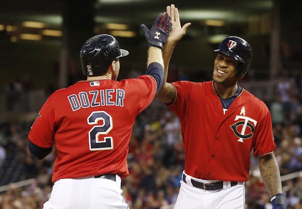 Twins center fielder Byron Buxton high-fived Brian Dozier after Dozier’s three-run homer against the White Sox on Friday night at Target Field.