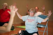 Bonnie Olson participated in a yoga class for people with Parkinson’s disease at Tarana Yoga Studio. At top, Amy Samson-Burke led the class.