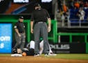 Miami Marlins' Giancarlo Stanton lies at second base after he was put out during the ninth inning of a baseball game against the Chicago White Sox, Sa