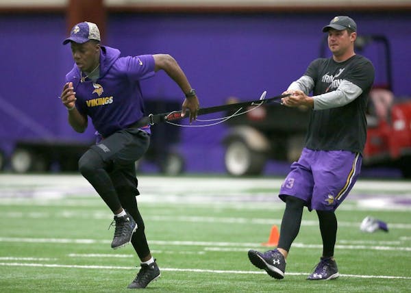 Minnesota Vikings quarterback Teddy Bridgewater, left, and Shaun Hill ran through drills during a player offseason workout at Winter Park, Tuesday, Ap