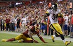 Pittsburgh Steelers running back DeAngelo Williams (34) crosses into the end zone as Washington Redskins defensive back David Bruton (30) watches from
