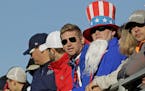 Fans watch from a grandstand above the driving range during a practice round for the Ryder Cup golf tournament Tuesday, Sept. 27, 2016, at Hazeltine N