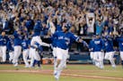 Toronto Blue Jays' Edwin Encarnacion celebrates while he rounds the bases after hitting a walk-off three-run home run during the 11th inning of an Ame