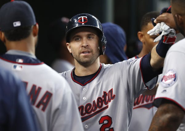 The Twins’ Brian Dozier (2) celebrated his solo home run against the Tigers in the third inning Monday, his 40th of the season.