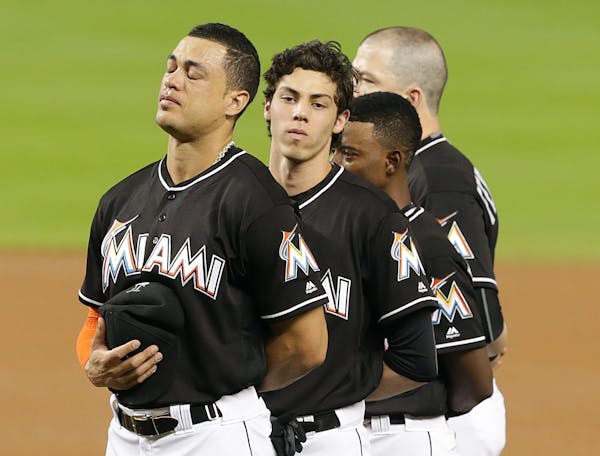 Miami Marlins Giancarlo Stanton, Christian Yelich, Dee Gordon and Justin Bour paid tribute on the field to pitcher Jose Fernandez, who died on a boat 