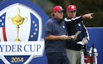 Phil Mickelson of the US looks along the 4th fairway from the tee box with his caddie during a practice round ahead of the Ryder Cup golf tournament a