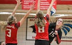 Kennedy Brady (15) spiked the ball past Shakopee defenders Mikaela Pavlicek (3) and Anna Blaschko (10), helping Lakeville North to a three-set victory