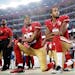 On Sept. 12, San Francisco 49ers safety Eric Reid and quarterback Colin Kaepernick kneel during the national anthem before an NFL football game agains