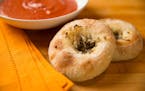 Bialys are filled with a mixture of sautéed onions and poppy seed, and the dough tips toward the salty side.