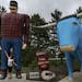 People have their photo taken near a large statue of Paul Bunyan and his blue ox, Babe, in Bemidji.