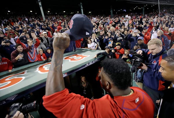 Boston Red Sox's David Ortiz salutes the crowd as he leaves the field at Fenway Park for the last time of the season following Game 3 of baseball's Am