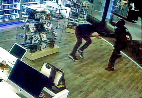 A frame grab from surveillance video taken of the St. Cloud mall attack shows Dahir Adan, right, using a knife to attack a mall worker at the beginnin