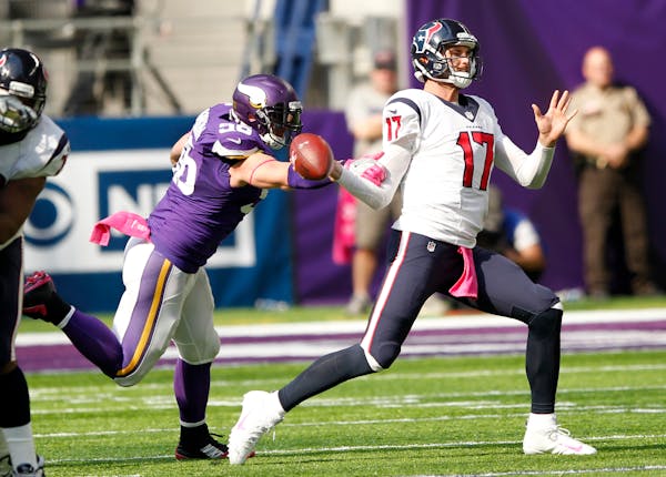 Minnesota Vikings defensive end Brian Robison, left, knocks the ball away from Houston Texans quarterback Brock Osweiler, right, during the second hal