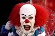 Tim Curry as Pennywise in “Stephen King’s It.”
