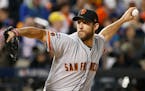 San Francisco Giants starting pitcher Madison Bumgarner (40) winds up during the first inning of a National League wild-card baseball game against the