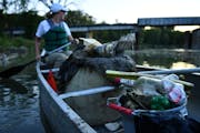 Trash, including bottles, cans and discarded clothes, filled the canoe of Christine Holland, project coordinator with the River Keepers, during a comm