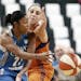 Minnesota Lynx's Renee Montgomery, left, passes the ball as Phoenix Mercury's Diana Taurasi defends in the second half of a WNBA playoff semi-finals b