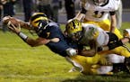 Rosemount quarterback Cody Hogan (7) dives into the end zone for a touchdown as Burnsville's Jackson Martens (5) is unable to stop Hogan during the fo