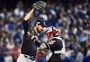 Cleveland Indians' Andrew Miller (24) and Roberto Perez (55) celebrate their victory over the Toronto Blue Jays in game three American League Champion