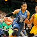 Minnesota Lynx's Maya Moore, left, drives around Los Angeles Sparks' Alana Beard in the second half during Game 5 of the WNBA basketball finals Thursd