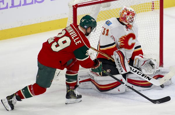 Wild right winger Jason Pominville looked for a rebound from Flames goalie Chad Johnson during the first period Tuesday night at Xcel Energy Center.