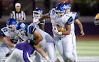Woodbury High running back Jalen Morrison (1) finds a hole in the Cretin-Derham Hall defense during the second quarter Friday, Sept. 9, 2016, at St. T