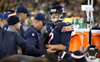Chicago Bears quarterback Brian Hoyer (2) is looked at on the sideline after suffering an injury in the second quarter of a game against the Green Bay