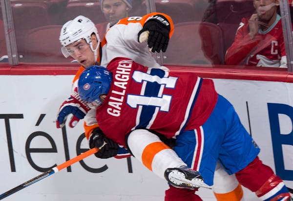 Philadelphia Flyers' Ivan Provorov (9) is taken out by Montreal Canadiens' Brendan Gallagher (11) during second period NHL hockey action in Montreal o