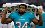 This Aug. 19, 2016 photo shows Miami Dolphins running back Arian Foster (34) walking along the sideline during an NFL preseason football game in Arlin