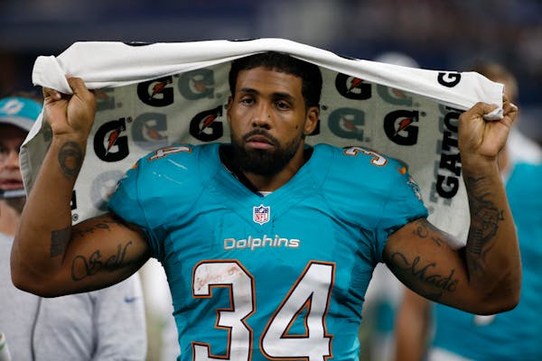This Aug. 19, 2016 photo shows Miami Dolphins running back Arian Foster (34) walking along the sideline during an NFL preseason football game in Arlin