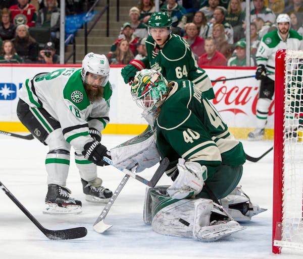 Minnesota Wild goalie Devan Dubnyk (40) stops a point blank shot by Dallas Stars right wing Patrick Eaves (18) during the second period of an NHL game