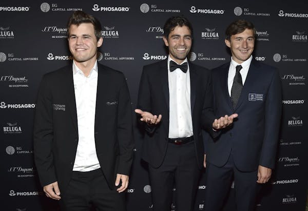 Current world chess champion Magnus Carlsen, from left, Adrian Grenier and chess grandmaster Sergey Karjakin attend the World Chess Championship Openi