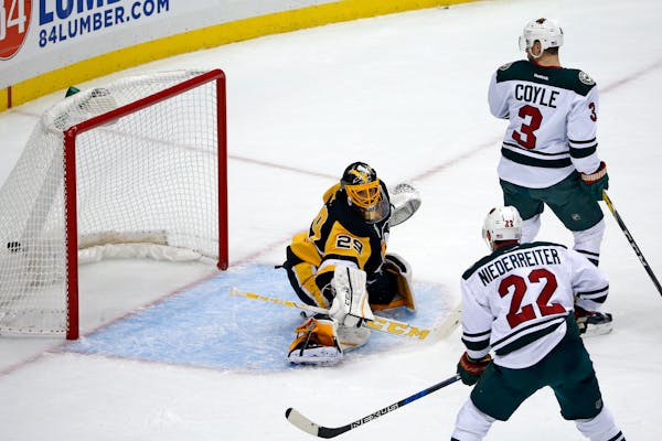 Minnesota Wild's Charlie Coyle (3) watches his deflection of a shot by Ryan Suter, past Pittsburgh Penguins goalie Marc-Andre Fleury (29) for a goal d