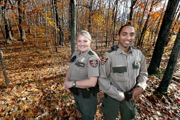 Minnesota conservation officers Leah Weyendt, left, and Arnaud Kpachavi have relished their work for the state.