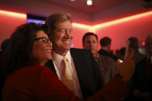 Jason Lewis took a selfie with supporter Susanne Miller of Burnsville as he worked the room at the Republican victory party.