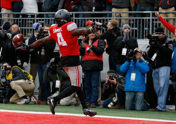 Ohio State running back Curtis Samuel celebrates his touchdown against Michigan during the second overtime of an NCAA college football game Saturday, 